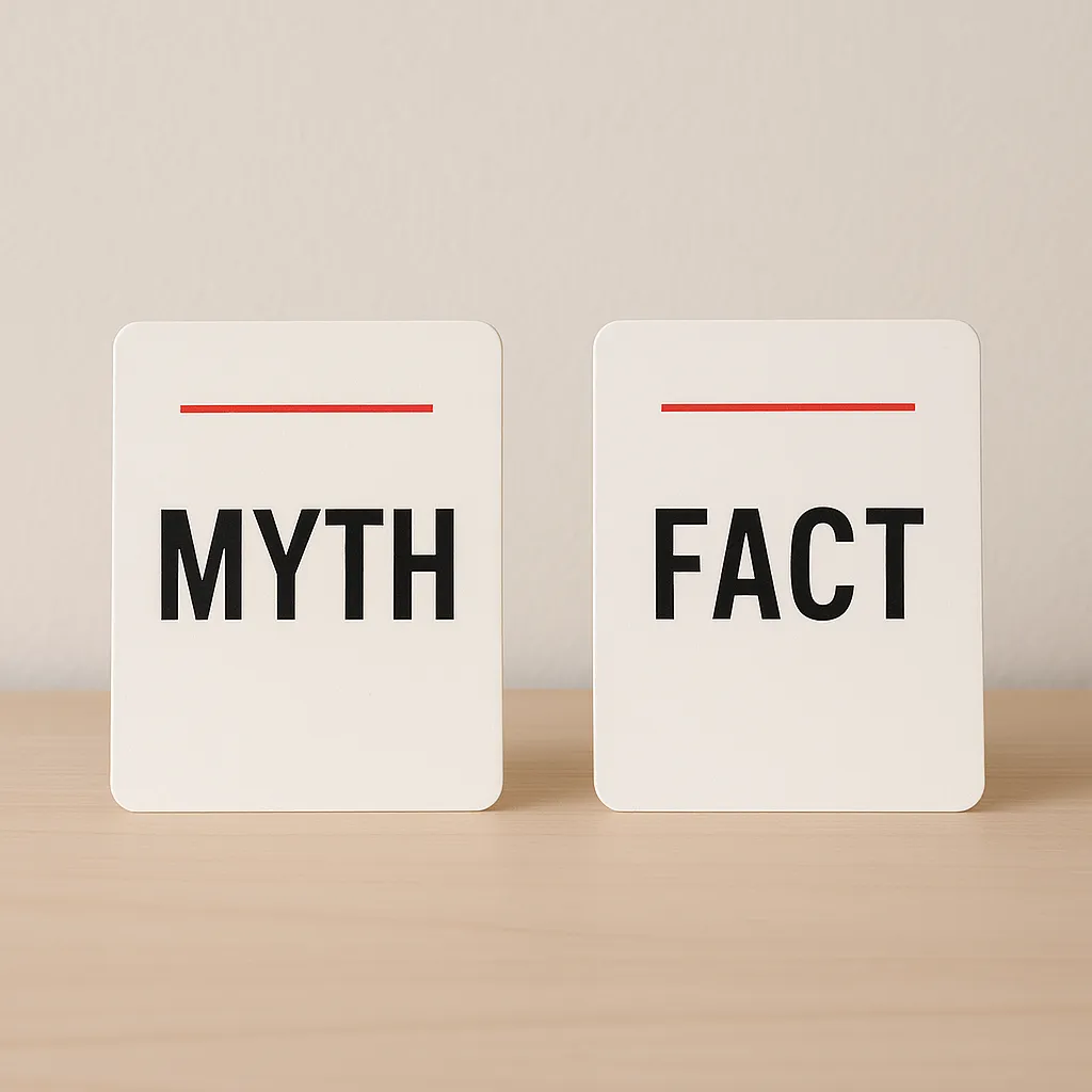 two cards labeled myth and fact on a desk